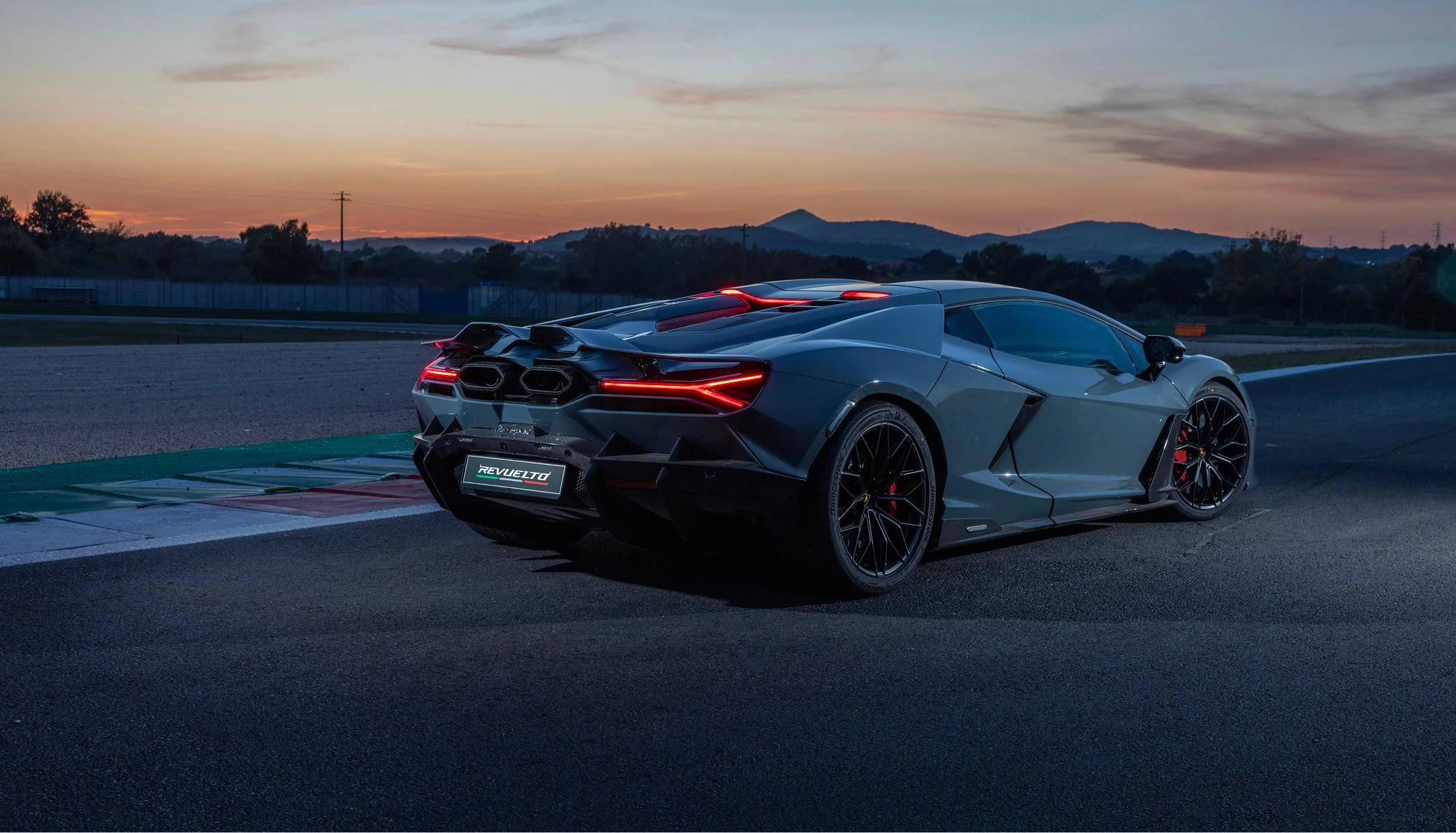Rear 3/4 on track at dusk (grey)